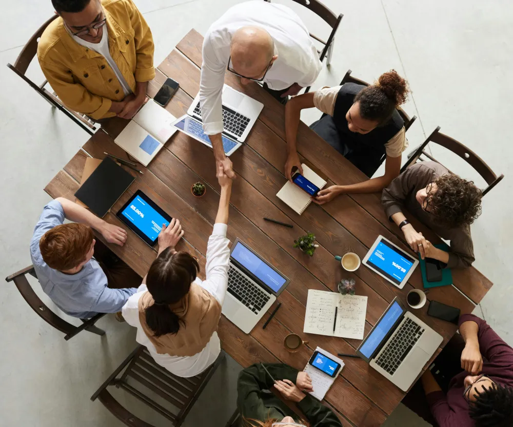 An overhead view of a table with colleagues around it
